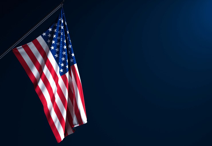 Flag of the United States of America on a dark background.